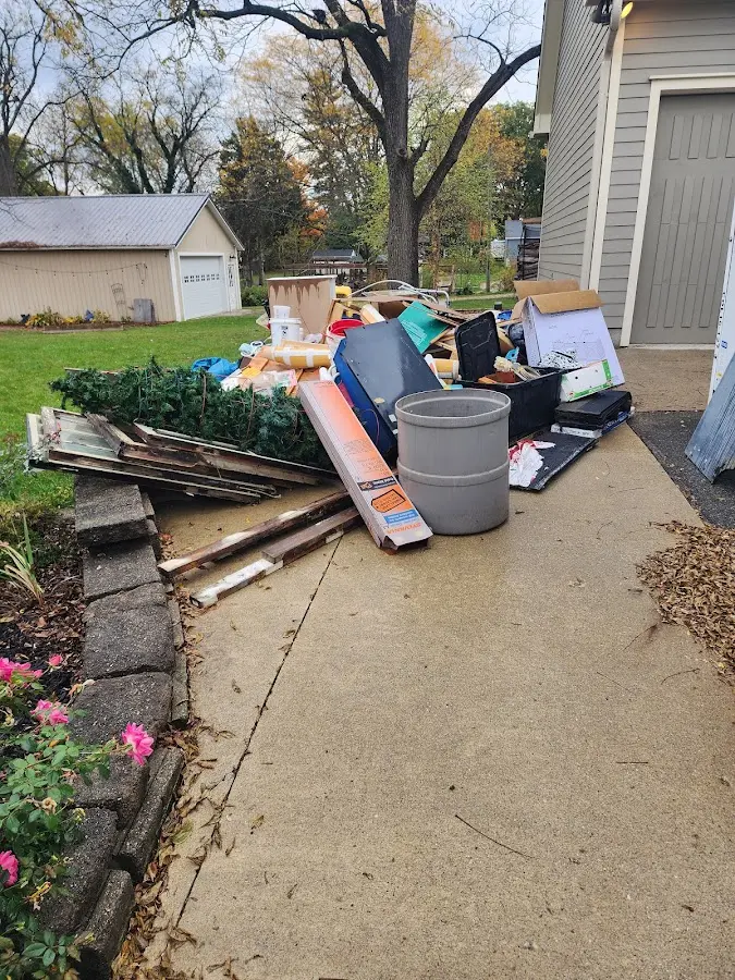 Dumpster being loaded with debris for Estate Cleanout Dumpster Rental in Wayland